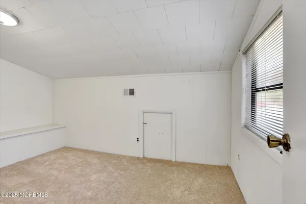 a view of an empty room and a window