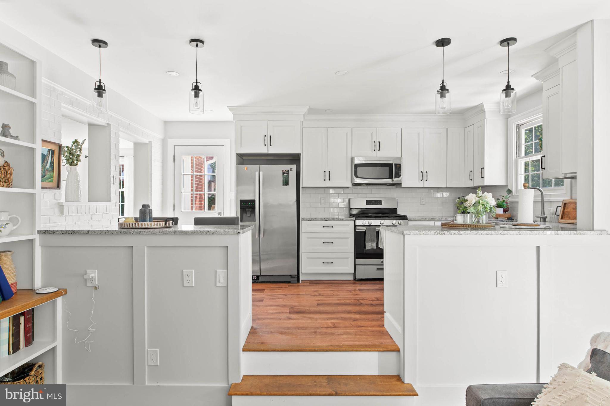 224 Wayne Avenue Springfield, PA 19064 - Photo 11 of 27 a kitchen with stainless steel appliances a refrigerator a stove a sink a dining table and chairs