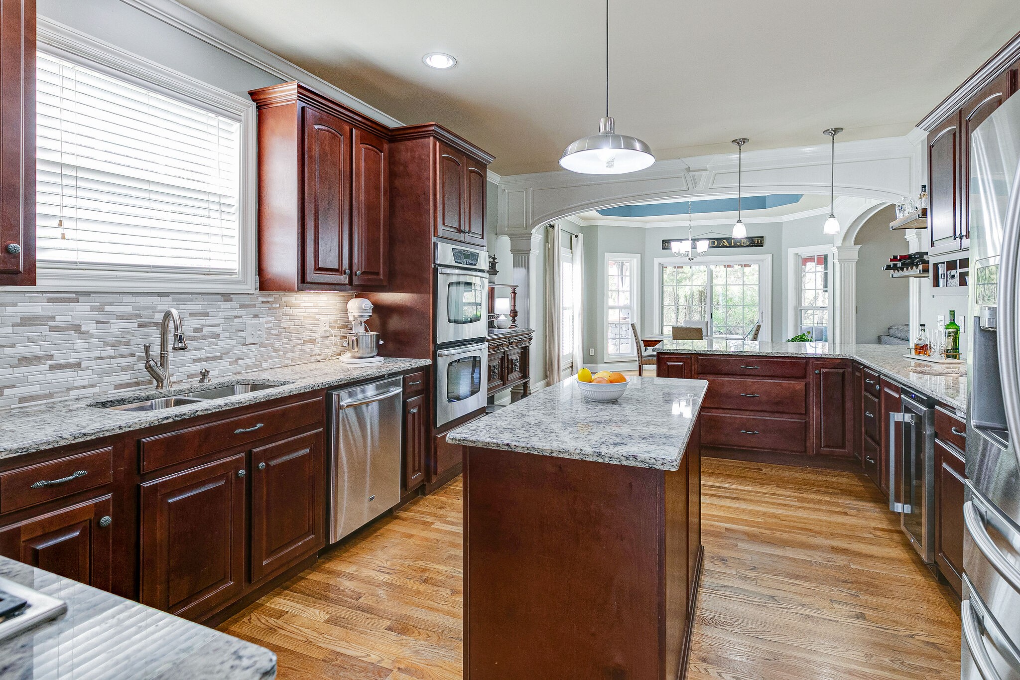 2003 Eylandt Court Spring Hill, TN 37174 - Photo 8 of 33 a kitchen with stainless steel appliances granite countertop wooden cabinets a stove a sink and a wooden floors