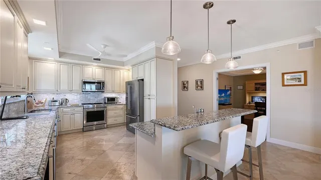 a large kitchen with a table and chairs
