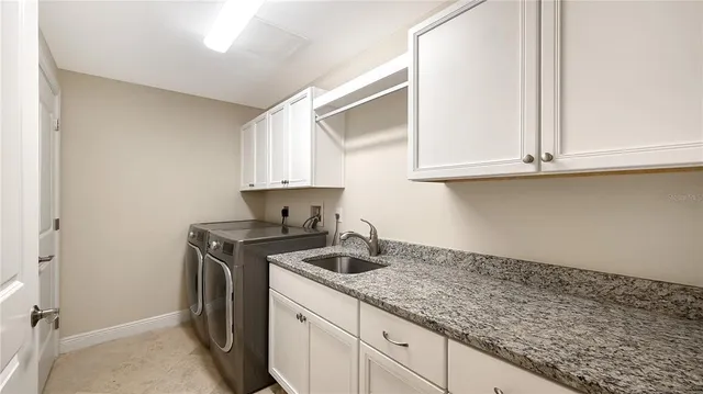 a kitchen with granite countertop cabinets stainless steel appliances and a sink