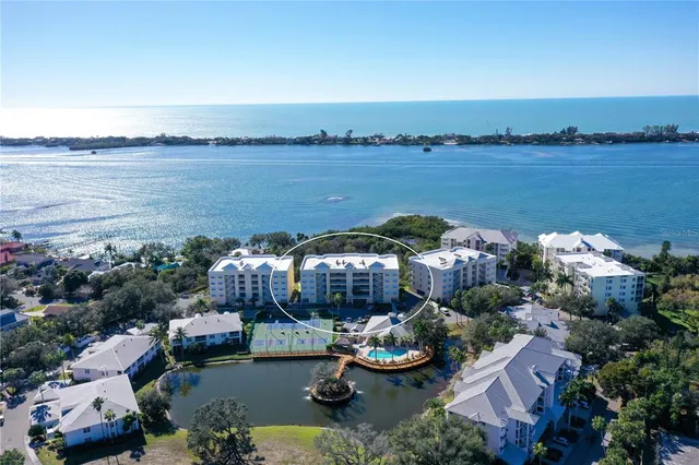 a view of a lake with couches and city view
