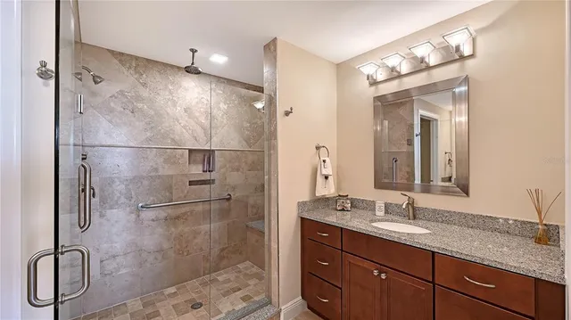 a bathroom with a double vanity sink mirror and shower