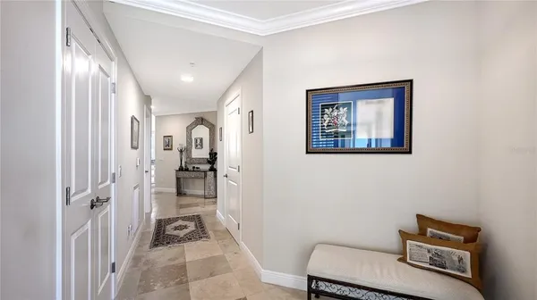 a view of a hallway with workspace and a couch