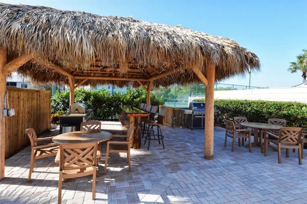 a view of a patio with table and chairs potted plants with wooden floor