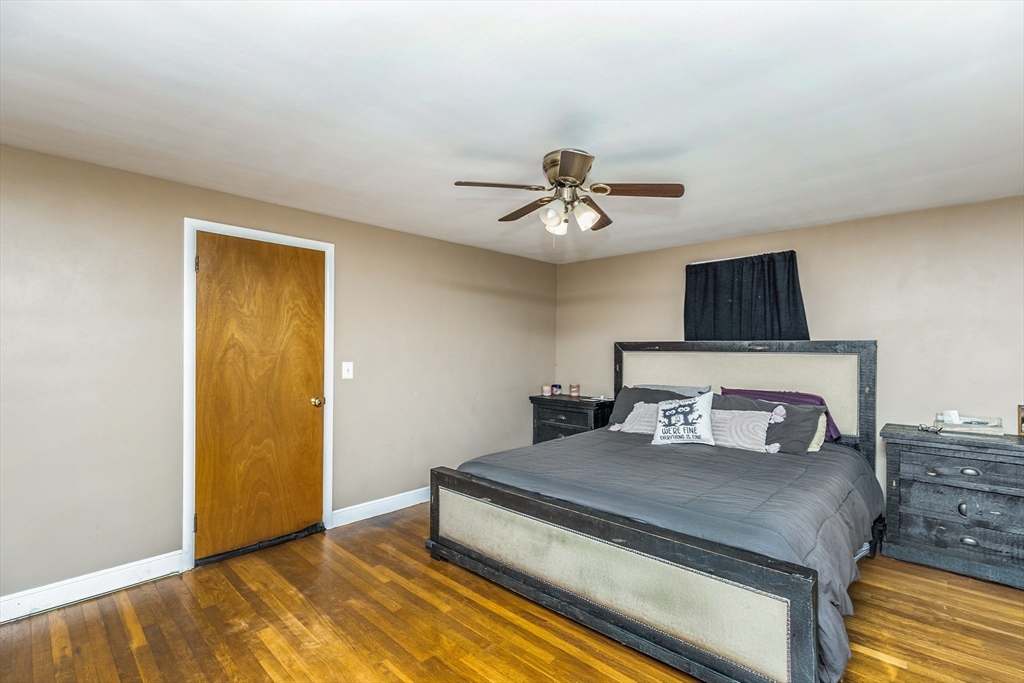 52 Albemarle Avenue, Unit 52 Lexington, MA 02420 - Photo 14 of 23 a bedroom with a bed and a chandelier