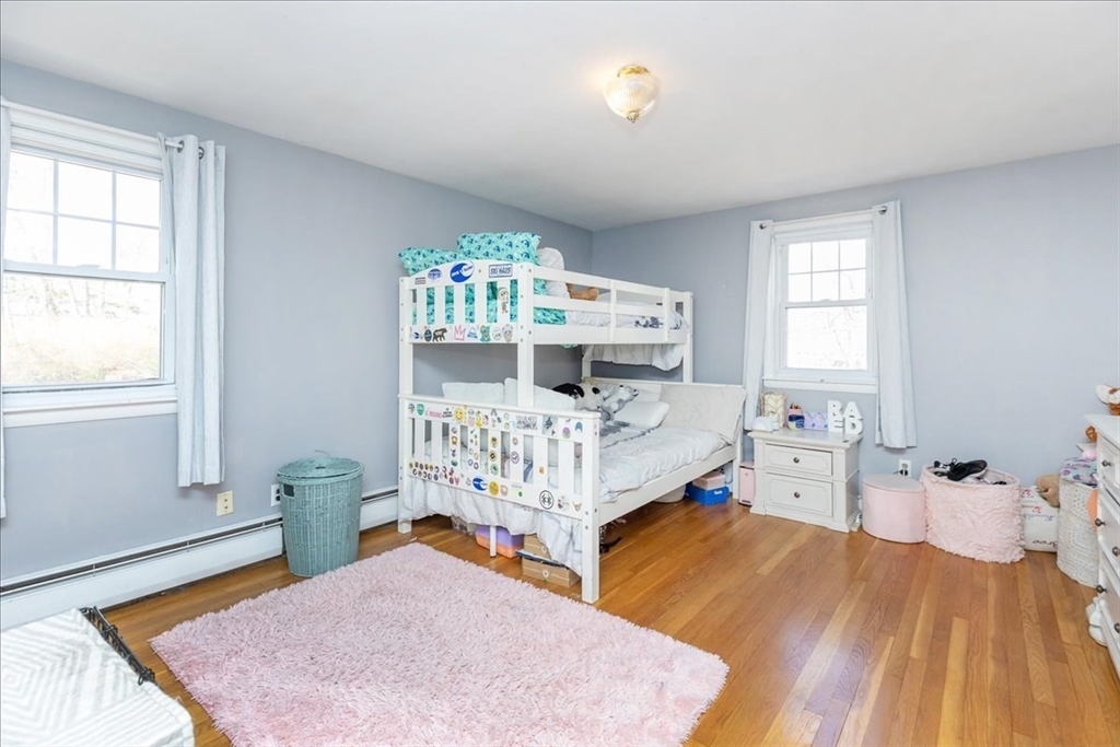 52 Albemarle Avenue, Unit 52 Lexington, MA 02420 - Photo 16 of 23 a bedroom with a bed and wooden floor