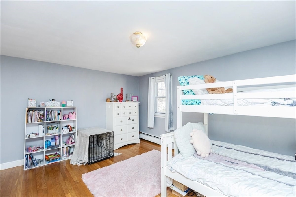 52 Albemarle Avenue, Unit 52 Lexington, MA 02420 - Photo 18 of 23 a bedroom with furniture and a book shelf
