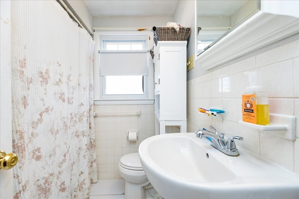 52 Albemarle Avenue, Unit 52 Lexington, MA 02420 - Photo 19 of 23 a bathroom with a sink a toilet and a mirror