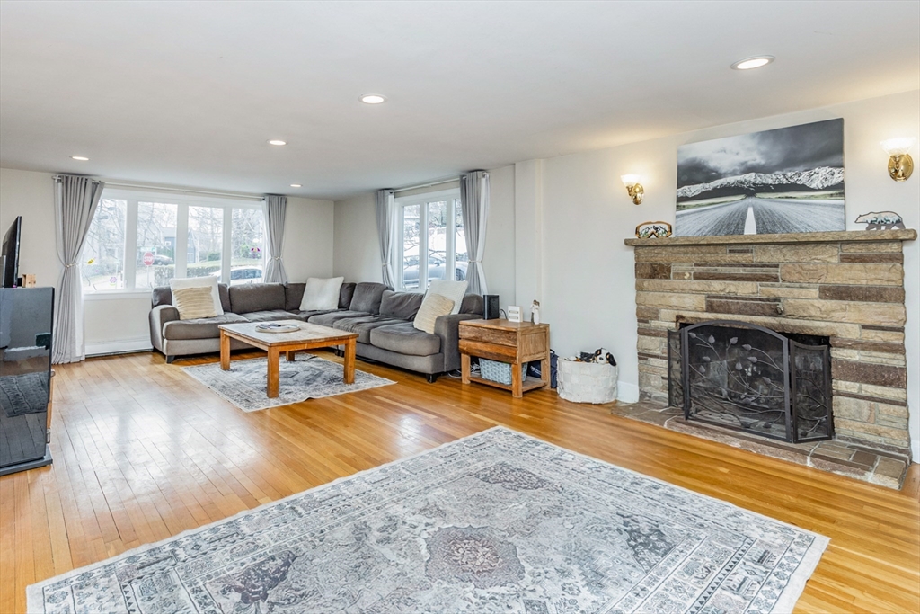 52 Albemarle Avenue, Unit 52 Lexington, MA 02420 - Photo 3 of 23 a living room with furniture and a fireplace