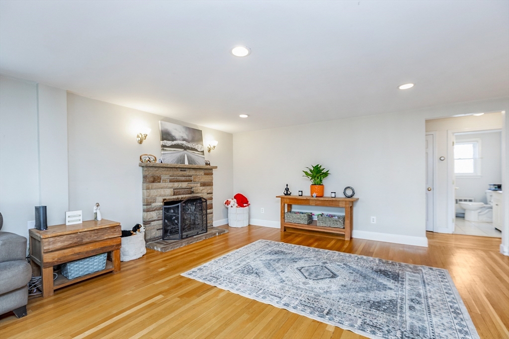 52 Albemarle Avenue, Unit 52 Lexington, MA 02420 - Photo 5 of 23 a living room with furniture and a fireplace