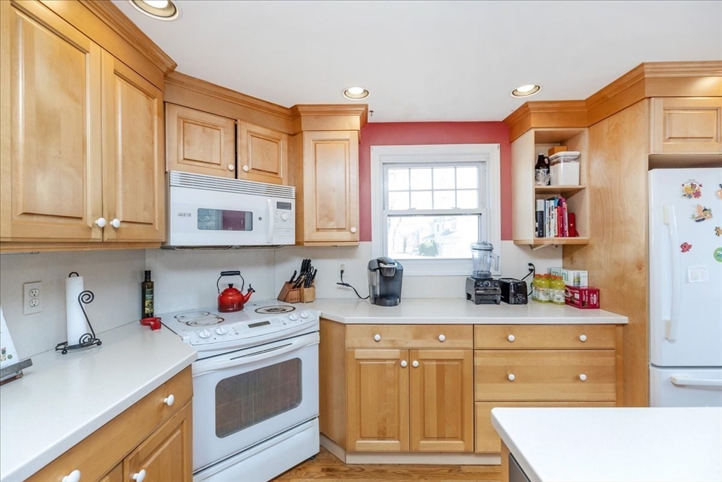 52 Albemarle Avenue, Unit 52 Lexington, MA 02420 - Photo 7 of 23 a kitchen with stainless steel appliances white cabinets and window