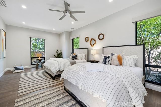 a bedroom with two beds and a large window