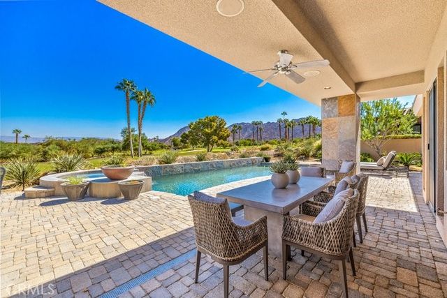 a view of a chairs and table in patio with a lake view