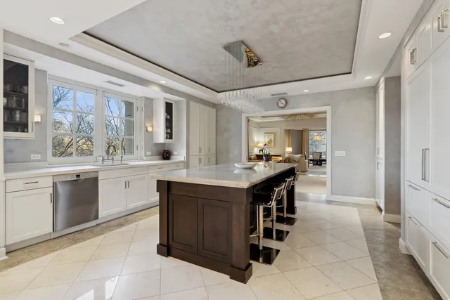 a kitchen with a sink and chairs