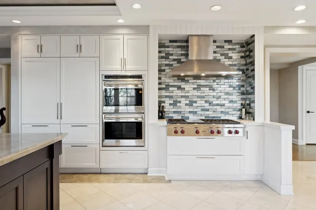 a kitchen with stainless steel appliances a refrigerator and a stove