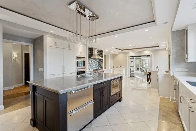 a kitchen with stainless steel appliances granite countertop a sink and cabinets