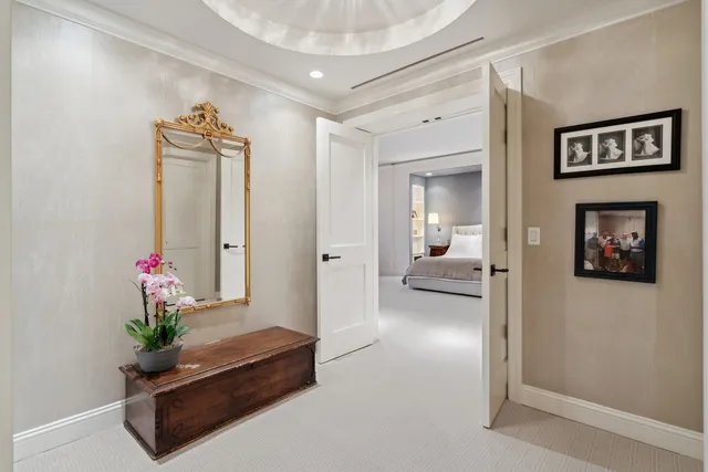 a spacious bedroom with a bed couch and a large window