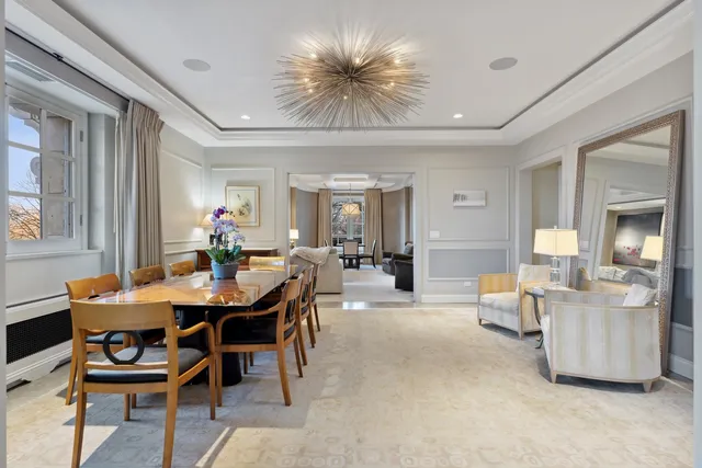 a view of a dining room with furniture and chandelier
