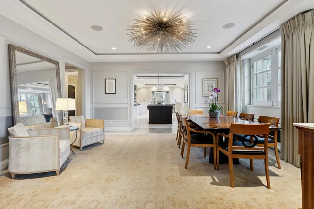 a living room with furniture and a dining table