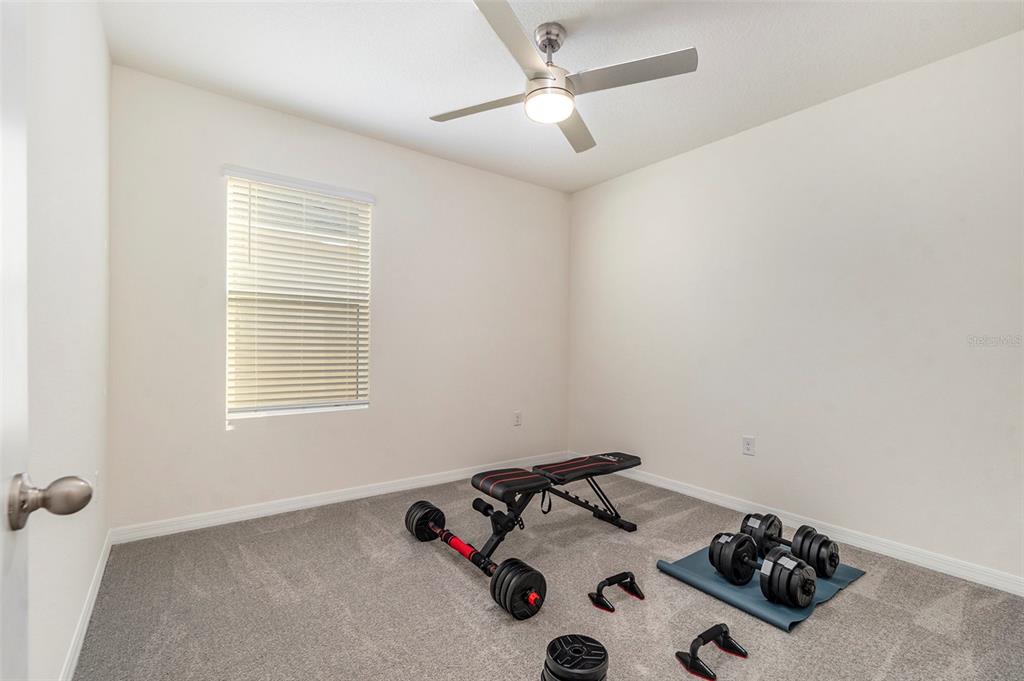 9319 Forge Breeze Loop Wesley Chapel, FL 33545 - Photo 22 of 45 a bedroom with a bed and a dresser