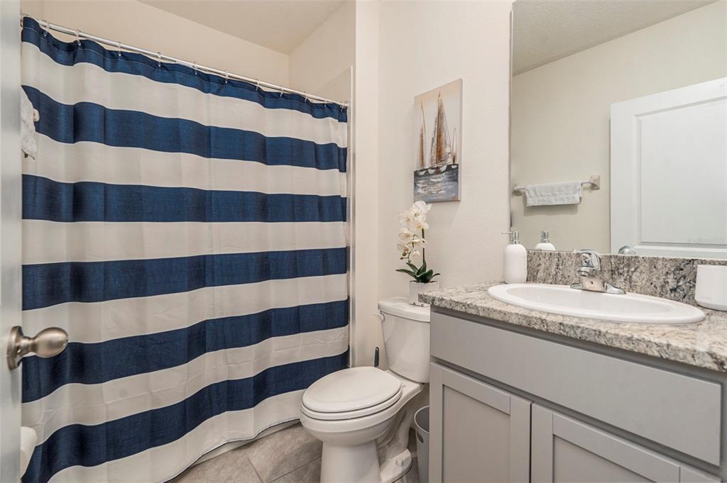 9319 Forge Breeze Loop Wesley Chapel, FL 33545 - Photo 24 of 45 a bathroom with a sink toilet and shower