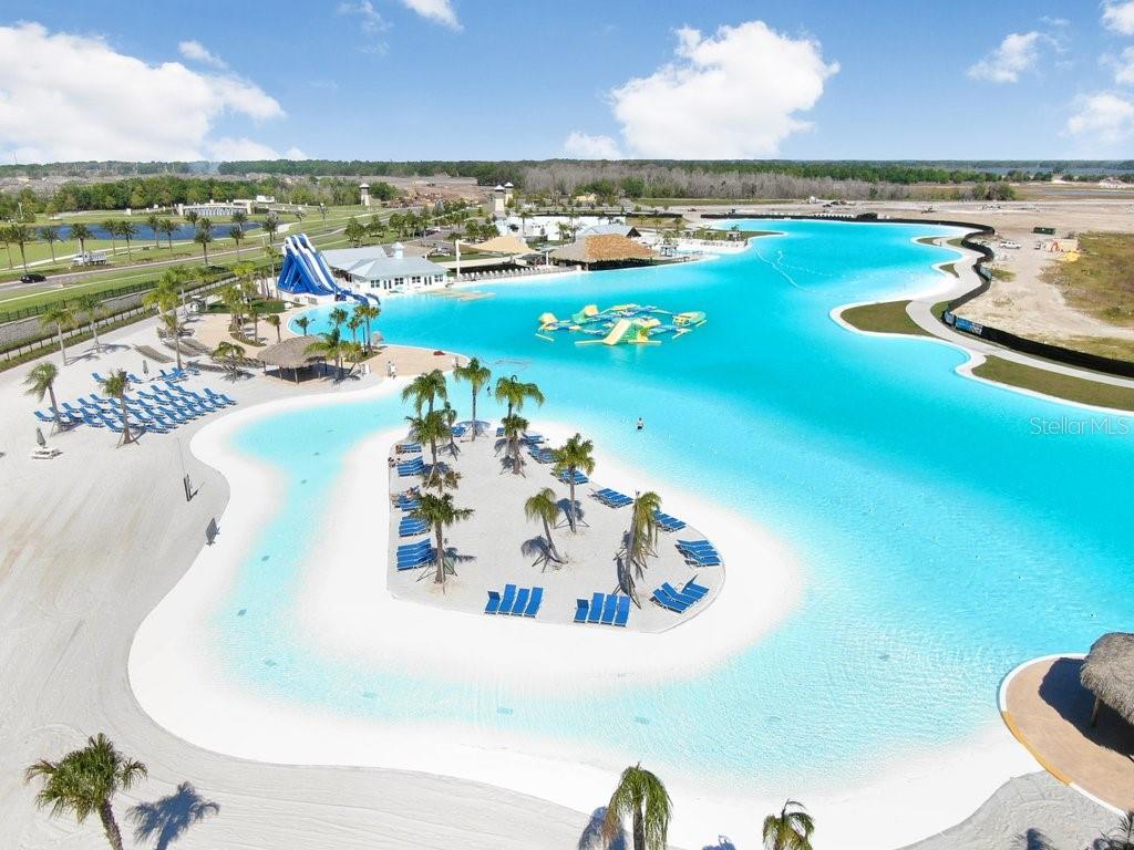 9319 Forge Breeze Loop Wesley Chapel, FL 33545 - Photo 32 of 45 a view of a swimming pool and a lake