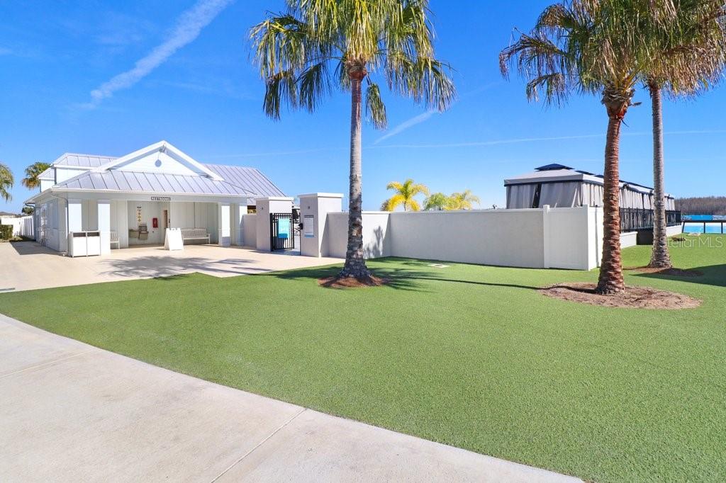 9319 Forge Breeze Loop Wesley Chapel, FL 33545 - Photo 41 of 45 a front view of a house with a garden and yard