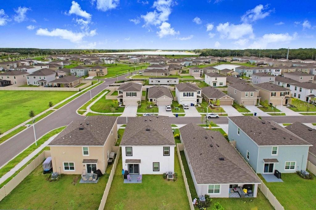 9319 Forge Breeze Loop Wesley Chapel, FL 33545 - Photo 9 of 45 an aerial view of multiple houses with a yard