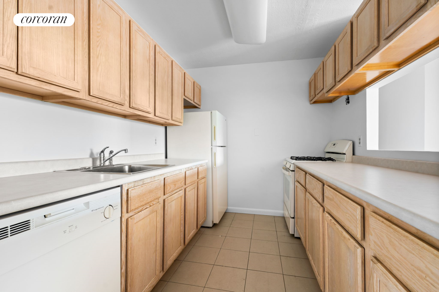 a kitchen with sink cabinets and a window