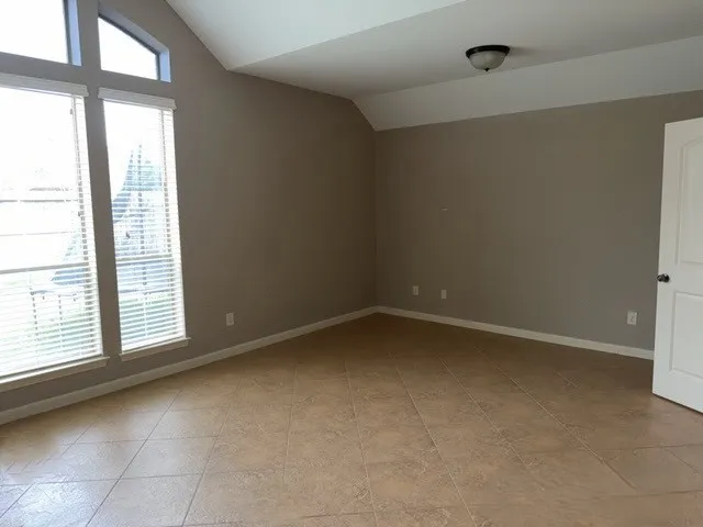 a bath tub sitting in a bathroom next to a window