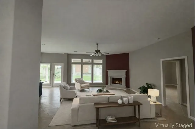a living room with furniture fireplace and a chandelier