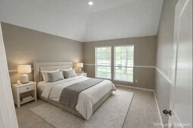 a bedroom with a bed and a large window