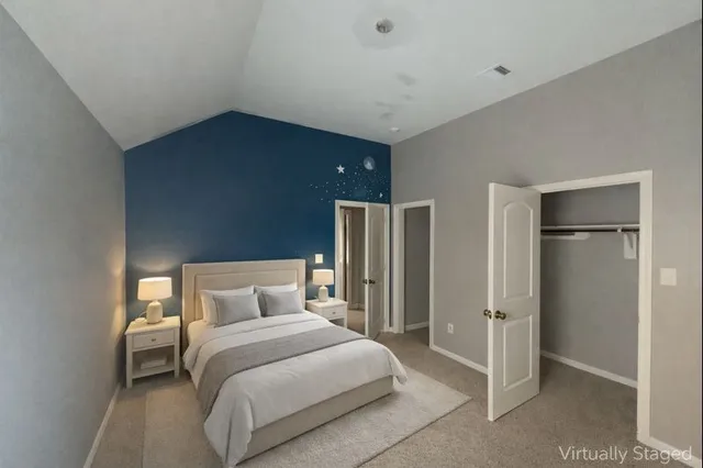 a bedroom with a bed and a refrigerator