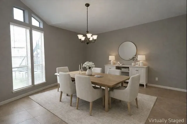 a view of a dining room with a table and chairs