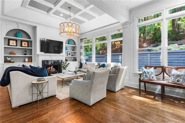 a living room with furniture a wooden floor and a large window