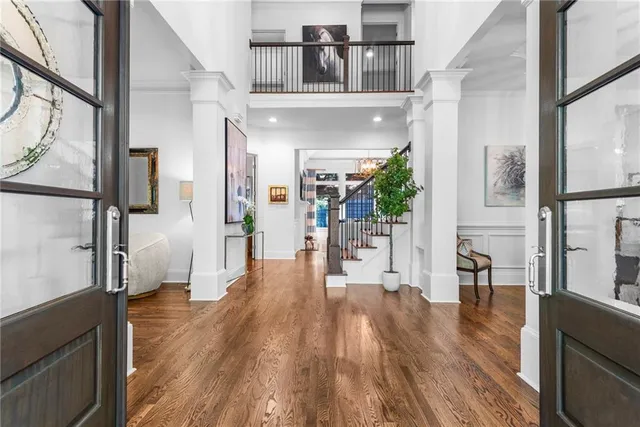 a view of entryway and hall with wooden floor