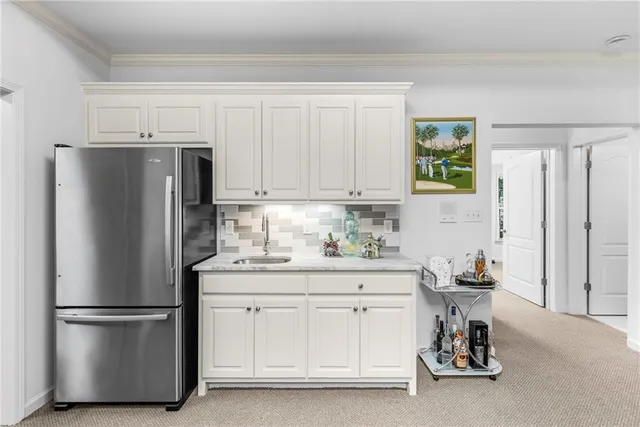 a view of a patio with table and chairs and potted plants