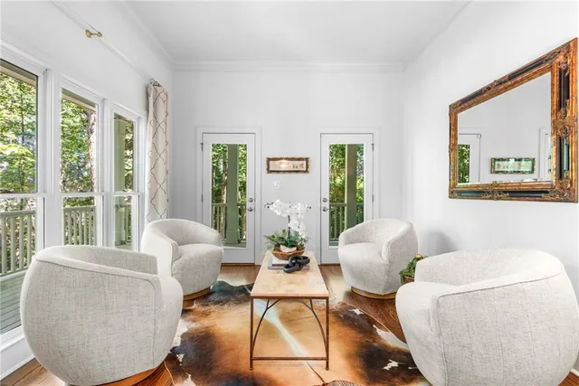 a dining room with furniture a chandelier and wooden floor