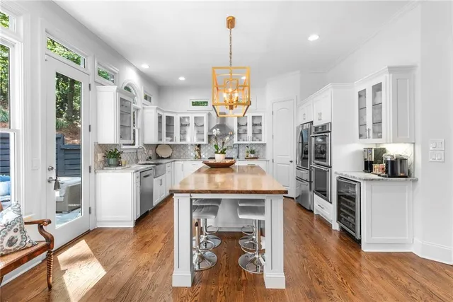 a kitchen with cabinets a window and stainless steel appliances