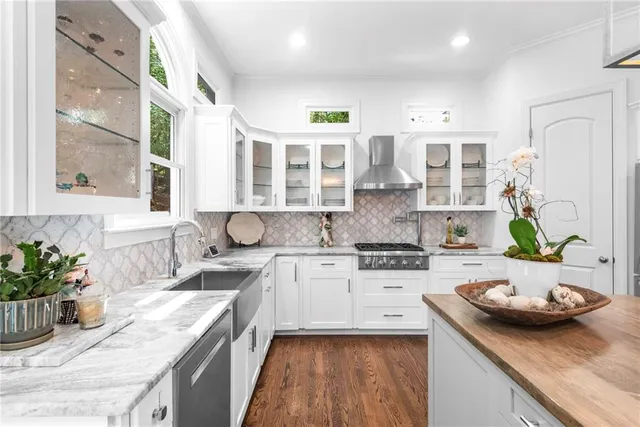 a kitchen with stainless steel appliances granite countertop a stove and a refrigerator