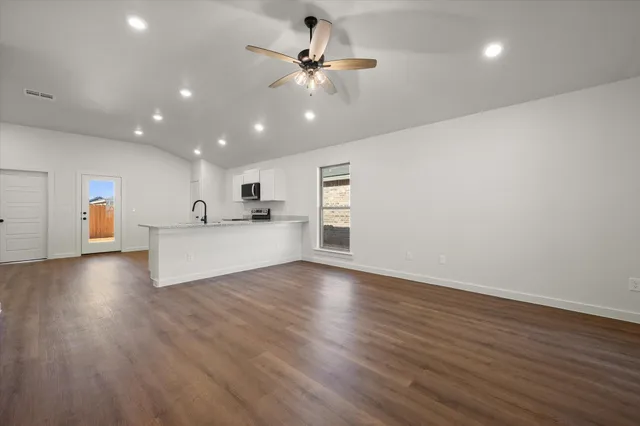 a view of a kitchen with a sink and a refrigerator