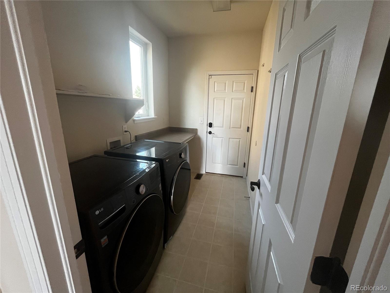 8121 Raspberry Drive Frederick, CO 80504 - Photo 11 of 27 a utility room with dryer and washer