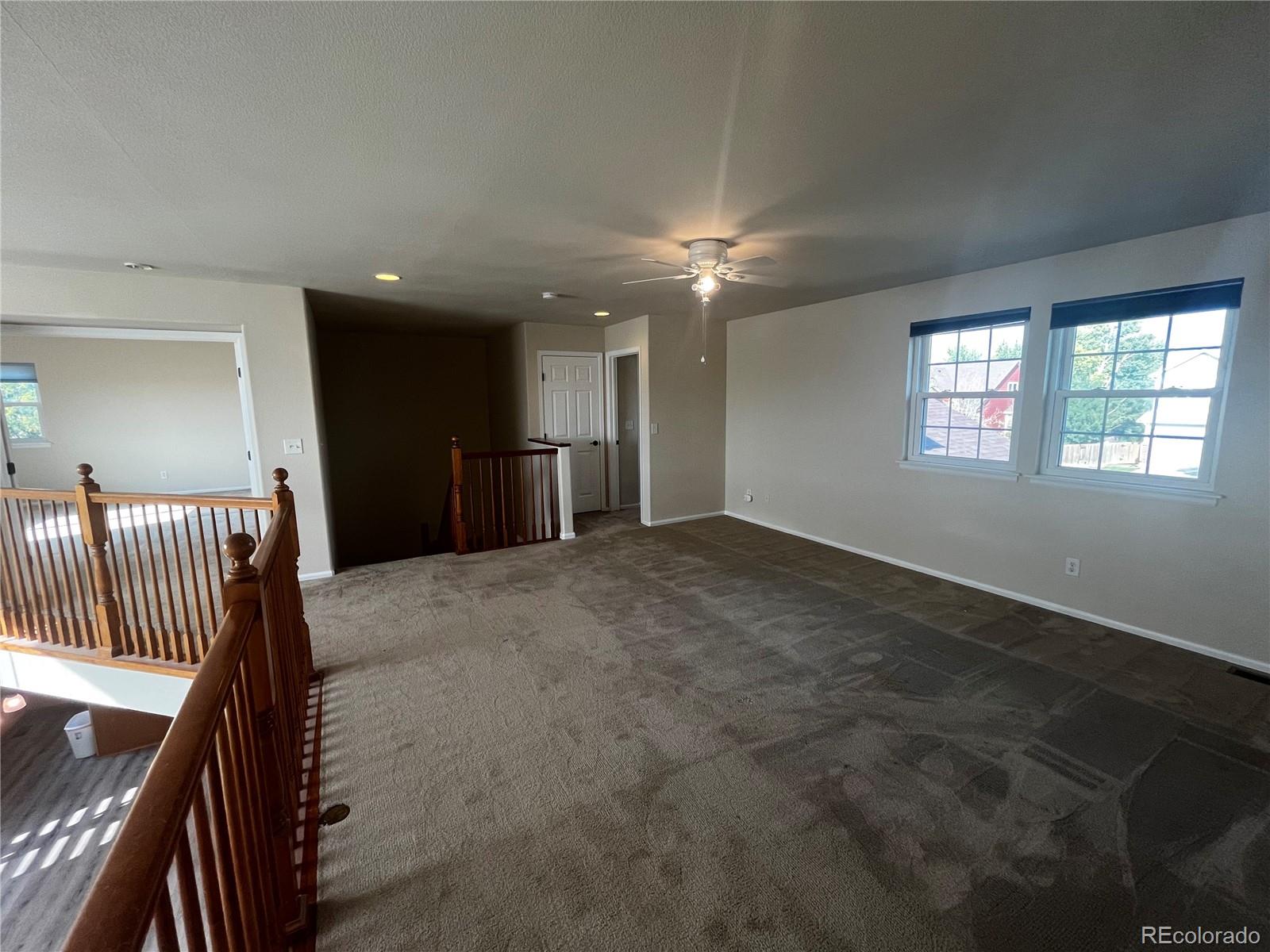 8121 Raspberry Drive Frederick, CO 80504 - Photo 13 of 27 an empty room with windows