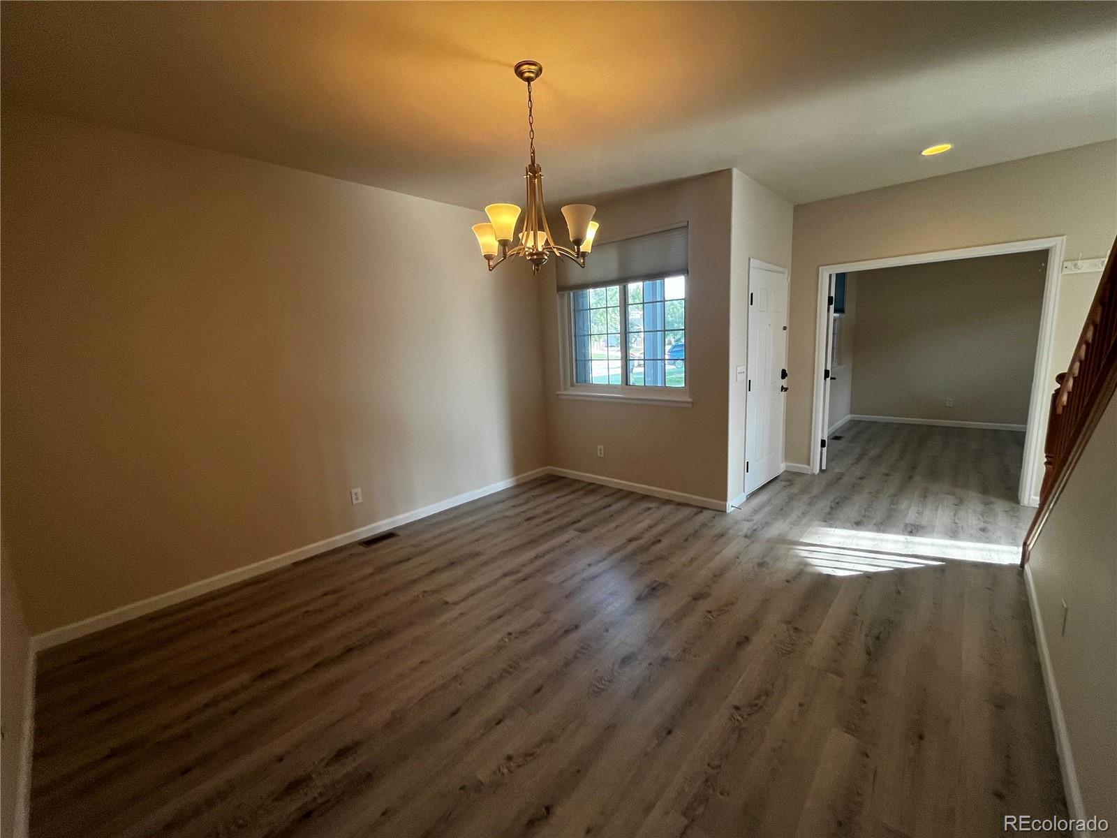 8121 Raspberry Drive Frederick, CO 80504 - Photo 3 of 27 an empty room with wooden floor and windows