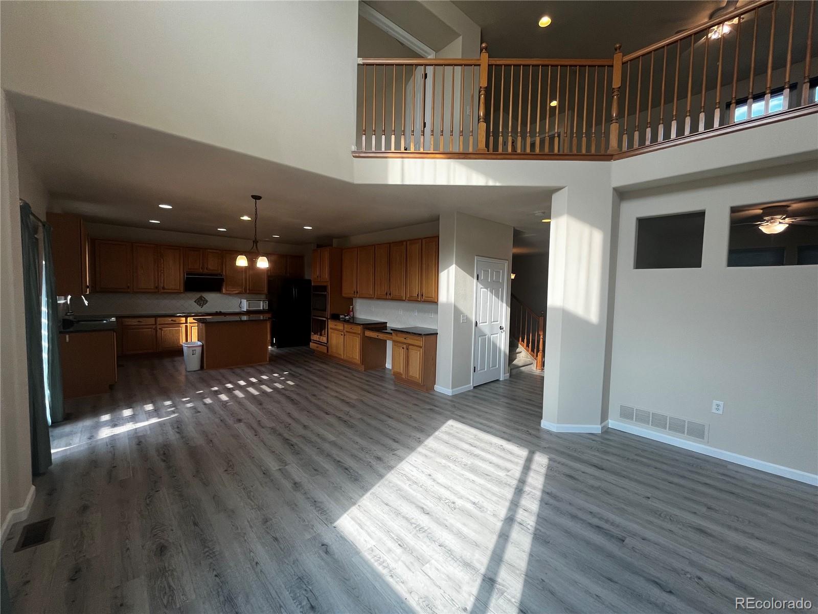 8121 Raspberry Drive Frederick, CO 80504 - Photo 6 of 27 a view of a hallway with wooden floor and staircase