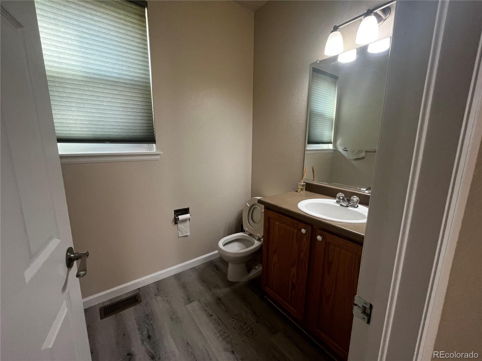 8121 Raspberry Drive Frederick, CO 80504 - Photo 10 of 27 a bathroom with a toilet sink and mirror