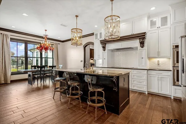 a hallway with sink mirror and cabinets