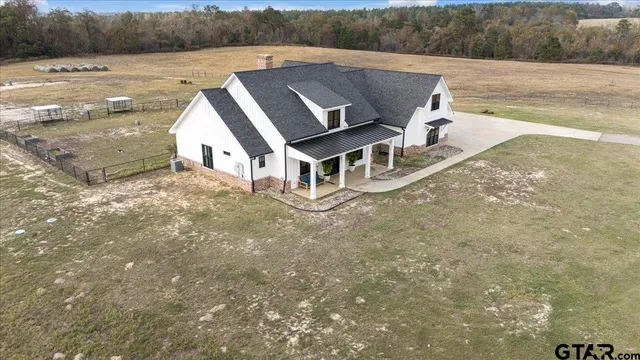 a view of a house with yard and sitting area