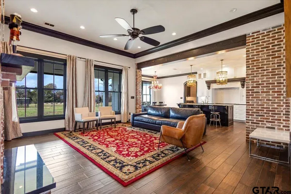 a living room with furniture a flat screen tv and a fireplace